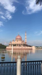 a large building with a tower on the water at Ailyah homestay in Putrajaya