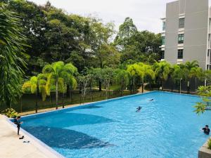 a large swimming pool with people in the water at Ailyah homestay in Putrajaya