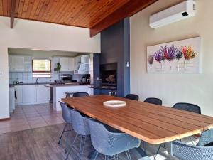 a kitchen and dining room with a wooden table and chairs at 'The Loft', 2 bedroom, sleeps 4, Central, Fantastic Views! in Cape Town