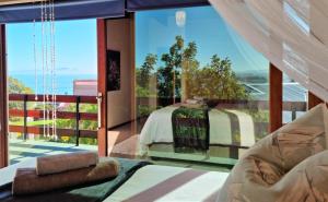 a bedroom with a bed and a large glass window at 'The Loft', 2 bedroom, sleeps 4, Central, Fantastic Views! in Cape Town +24 photos