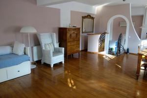 a living room with a bed and chairs and a table at Villa Dendron in Aghia Marina