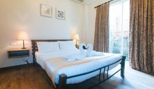 Postel nebo postele na pokoji v ubytování RedDoorz Premium at Anisabel Suites Davao City