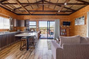 a kitchen and living room with a table and chairs at Abendruhe Lodge in Pretoria