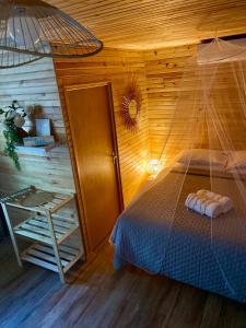 a bedroom with a bed with a net at Rangiroa Beach House in Avatoru