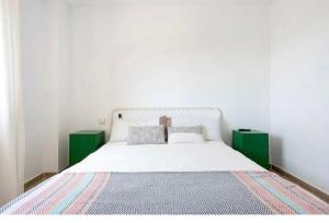 a bedroom with a large white bed with two green cabinets at Paraíso zahara in Zahara de los Atunes +11 photos