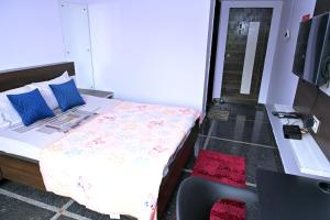 a bedroom with a bed and a glass door at Anyhour Stay in Gannavaram