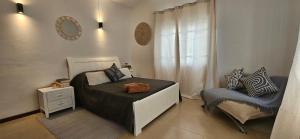 a small bedroom with a bed and a chair at Ground Floor Apartment near Pereybere Beach in Pereybere