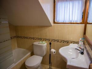 a bathroom with a toilet and a sink and a tub at Large Villa in Cantabria in Arnuero