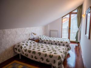 two beds in a small room with a window at Large Villa in Cantabria in Arnuero