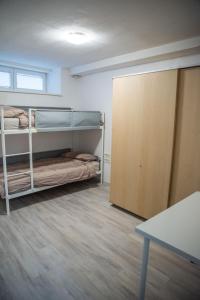 a room with two bunk beds and a table at Apartma Katja in Škofja Loka