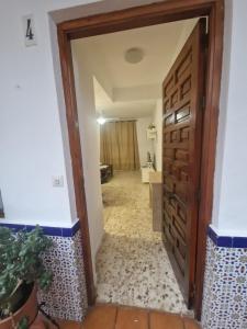 a door leading into a hallway with a bathroom at Vivienda Turística en la Muralla de San Basilio in Córdoba +13 photos