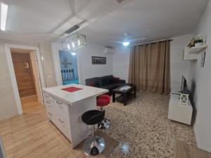 a living room with a couch and a desk in a room at Vivienda Turística en la Muralla de San Basilio in Córdoba