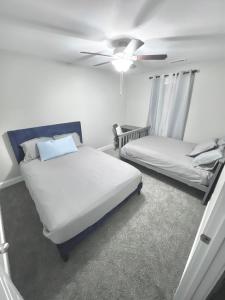 a bedroom with two beds and a ceiling fan at Spotless in Clarksville