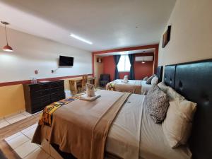 a hotel room with two beds and a television at Hotel San Rafael in Poza Rica de Hidalgo