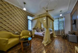 a bedroom with a bed and a couch and a window at hotel pearl continental in Srinagar