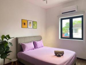 a bedroom with a bed with a purse on it at Modern Cozy House 4 ROOM 10pax@Bukit Mertajam in Bukit Mertajam