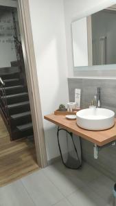 a bathroom with a sink and a staircase at Arduino41 in San Martino Canavese