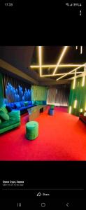 a room with blue and green chairs and a red carpet at level 77 in Ulaanbaatar