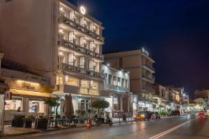 a building on a city street at night at Lesvion Hotel in Mytilene