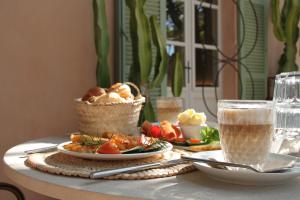 una mesa con platos de comida y una cesta de pan en Yartan Boutique Hotel - Adults Only, en Artà