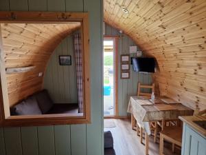 a room with a large window in a tiny house at Hillside Havens in Dufftown