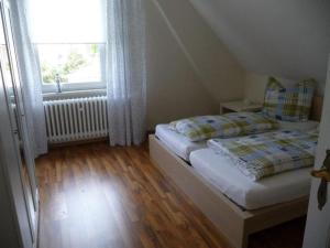 a small bedroom with two beds and a window at Ferienwohnung Ida in Ahlbeck