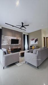 a living room with two couches and a ceiling fan at Lodge 16 Private Villa in Kuah