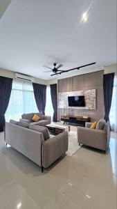 a living room with two couches and a tv at Lodge 16 Private Villa in Kuah