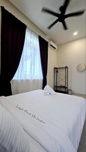 a bedroom with a white bed with a ceiling fan at Lodge 16 Private Villa in Kuah +23 photos