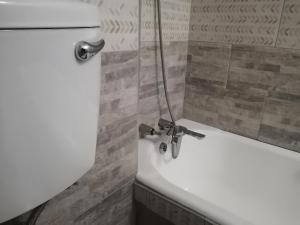 a bathroom with a white sink and a bath tub at Modern style Apartment in Pretoria-Central in Pretoria