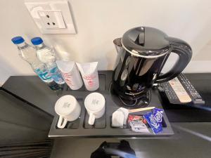 a black counter with a blender and bottles of water at Gazebo Inn & Suites Medanta in Gurgaon