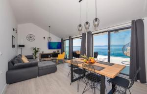 a living room with a table and a couch at Sun Paradise Apartment in Podgora