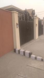 a black gate on the side of a house at Chinaka guest house in Lagos
