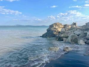 a view of the ocean with rocks and water at Our dreamy holiday home by the sea in Pomorie