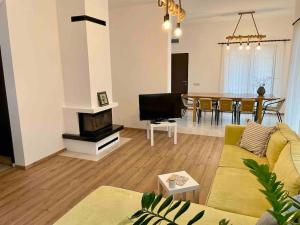 a living room with a couch and a dining room at Our dreamy holiday home by the sea in Pomorie