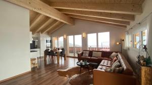 a living room with a couch and a table at Bergquelle Dachwohnung in Bettmeralp