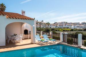 uma villa com uma piscina e um pátio em Villas Playas de Fornells em Fornells