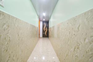 a hallway with a door in a building at FabExpress MU Club in Patna