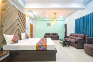 a bedroom with a bed and a living room at FabExpress MU Club in Patna