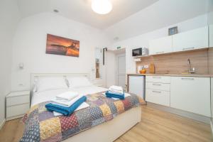 a bedroom with a bed with towels on it at Studio apartment JELI in Cavtat