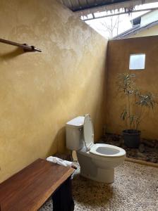 a bathroom with a toilet in the corner of a room at Sawasdee Lagoon Camping Resort in Ban Lam Pi