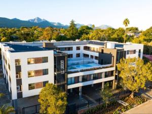 an aerial view of a building with trees and mountains at 103 Le Jardin in George