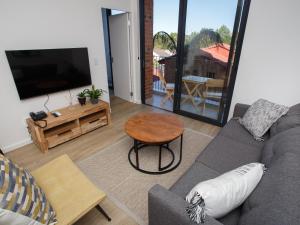 a living room with a couch and a table at 103 Le Jardin in George