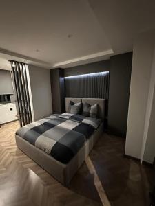 a bedroom with a large bed in a room at Room Studio in Tirana