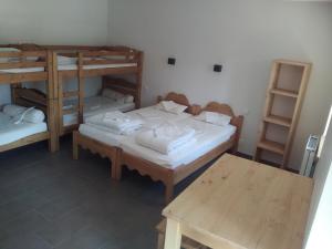 a room with two bunk beds and a table at Cap Verb Guillestre in Guillestre