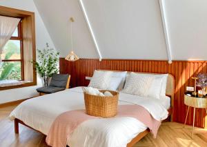a bedroom with a bed with a basket on it at กลิ่นไอทุ่งโฮมสเตย์ in Ban Thum