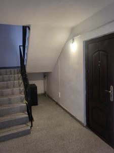 an empty hallway with a staircase and a door at King srl in Craiova