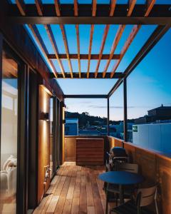 a balcony with a table and chairs on a building at Beautiful urban apartment 4 in Nelson
