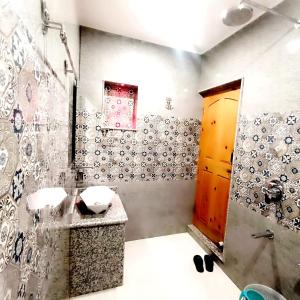 uma casa de banho com um lavatório e um chuveiro em Waneposh Residency em Srinagar