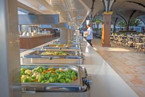 a buffet line with many trays of food at Adams Beach Hotel & Spa in Ayia Napa